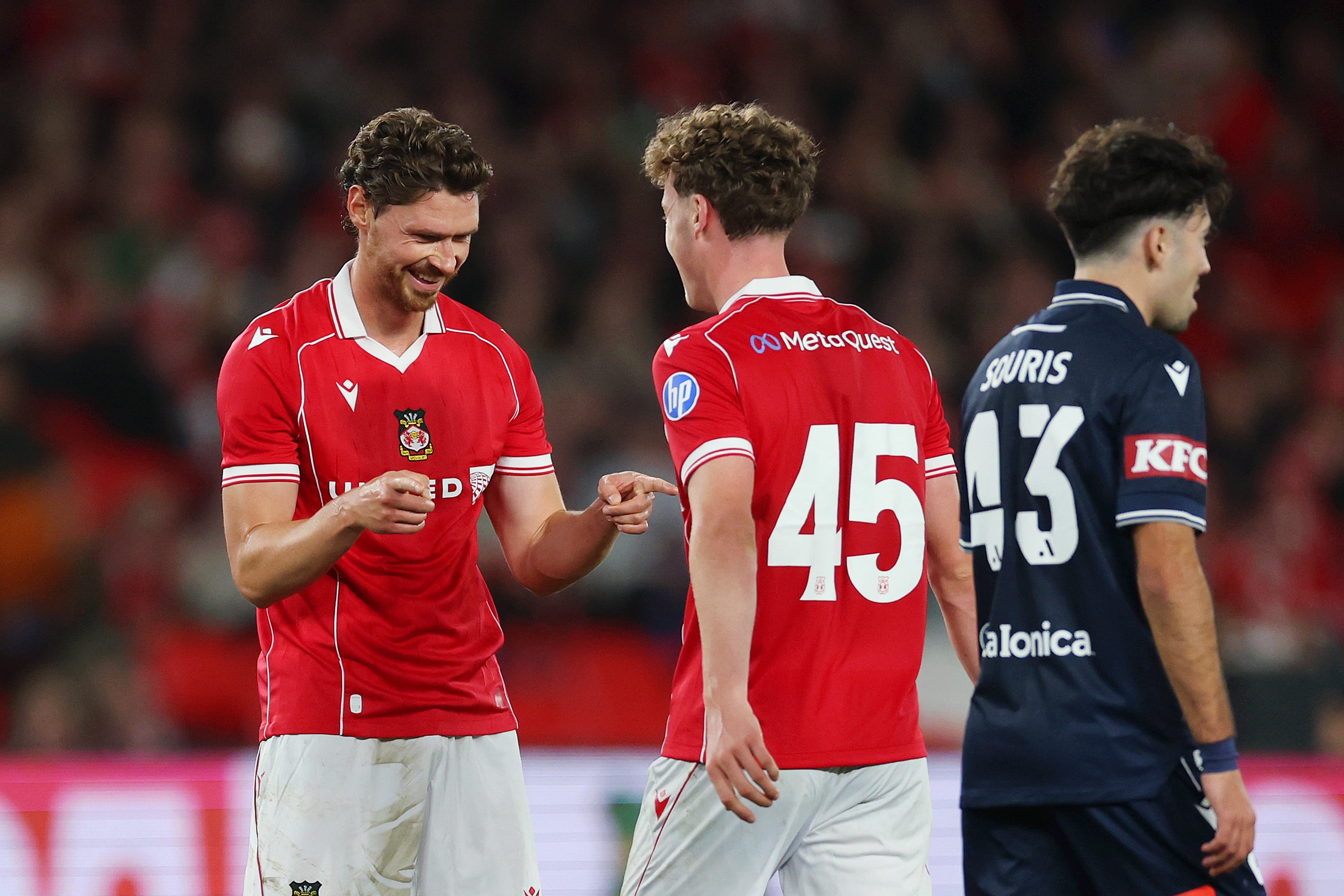 George Evans of Wrexham celebrates with teammate Harry Ashfield
