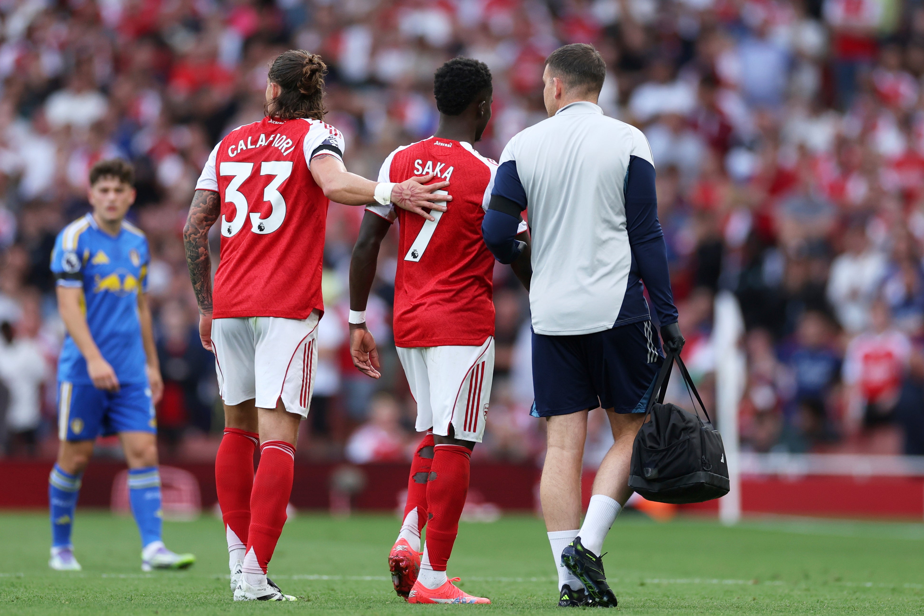 Saka was then helped off the field