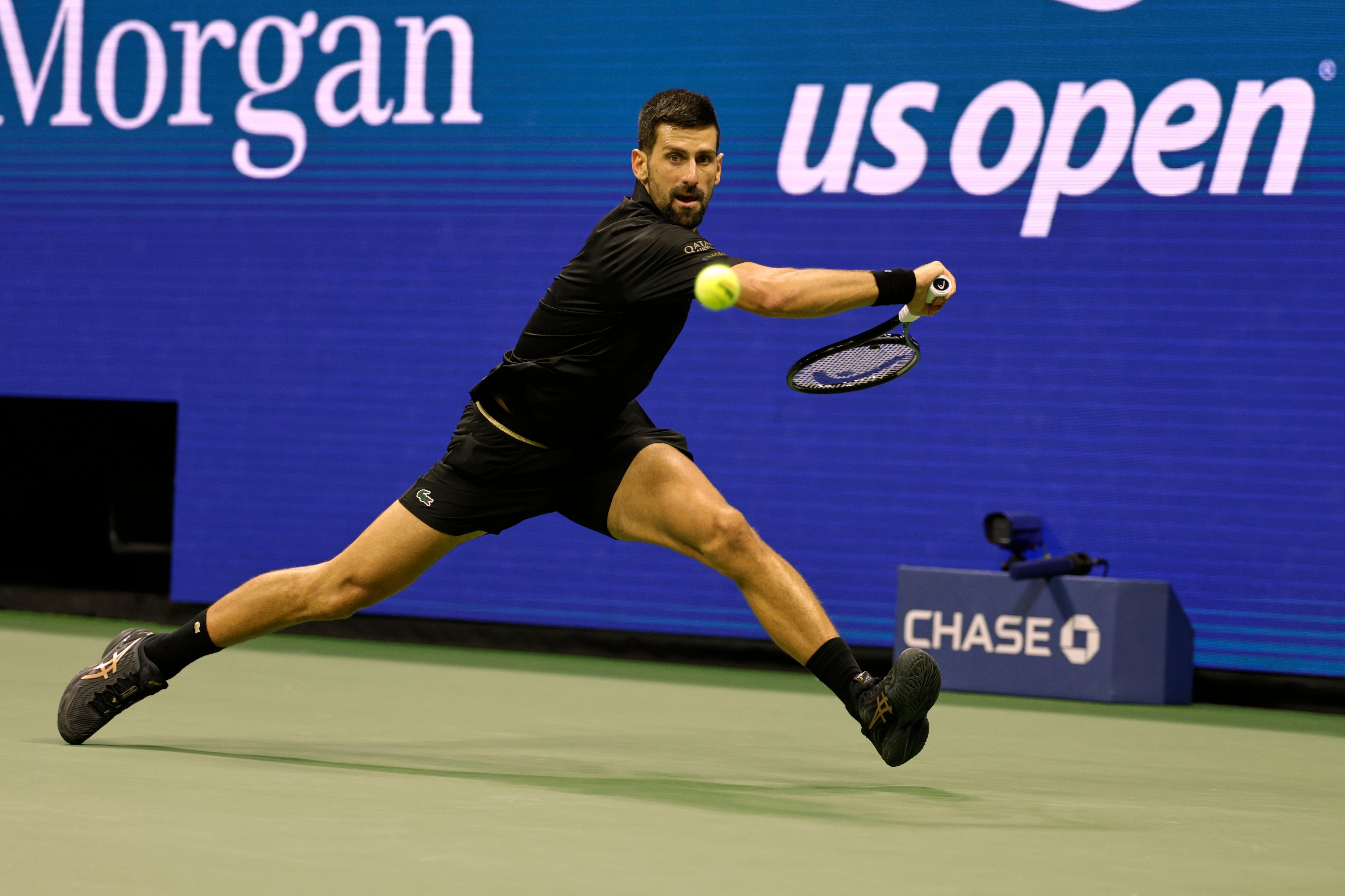 Novak Djokovic at full stretch against Taylor Fritz