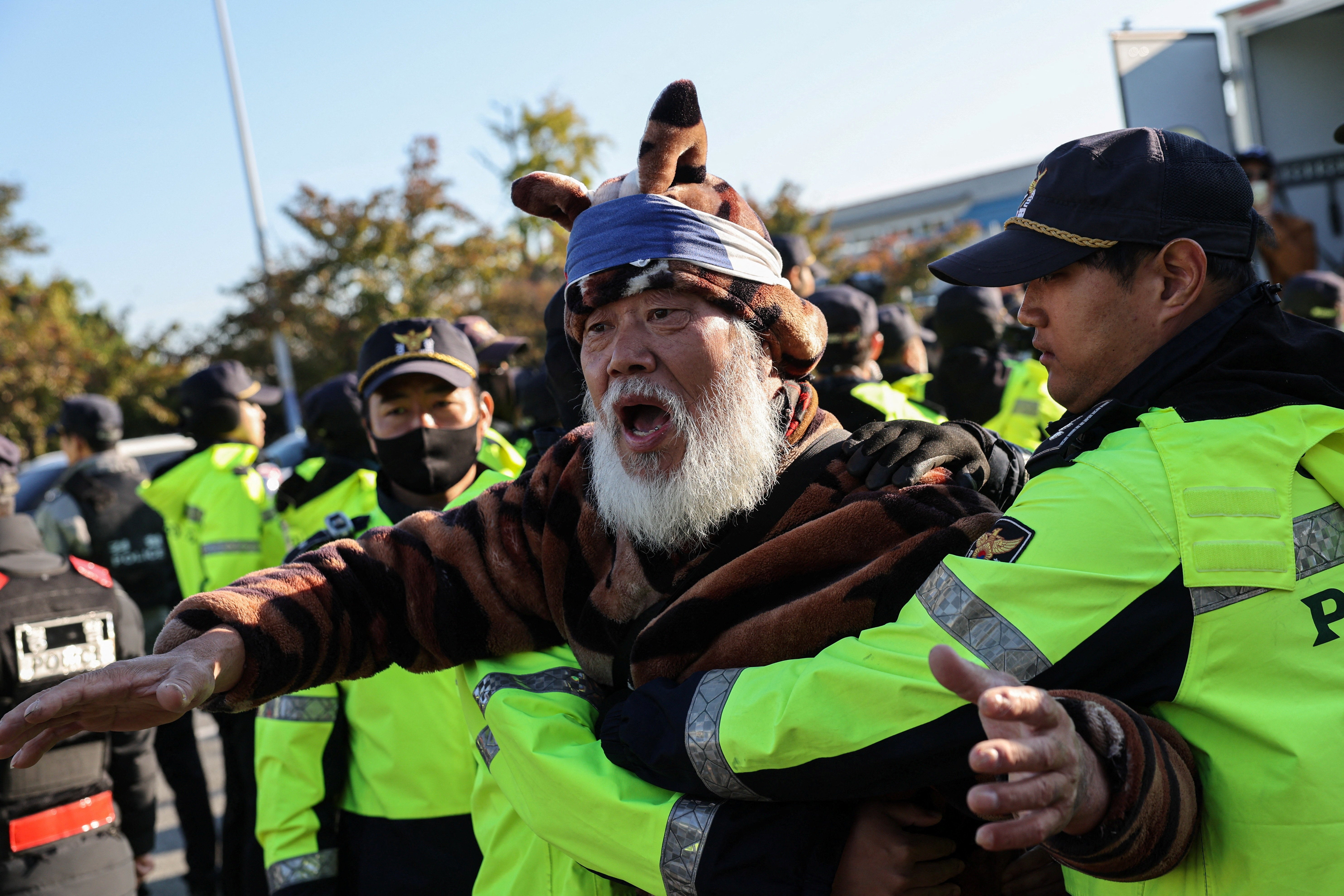 South Korean police stop an anti-China protester