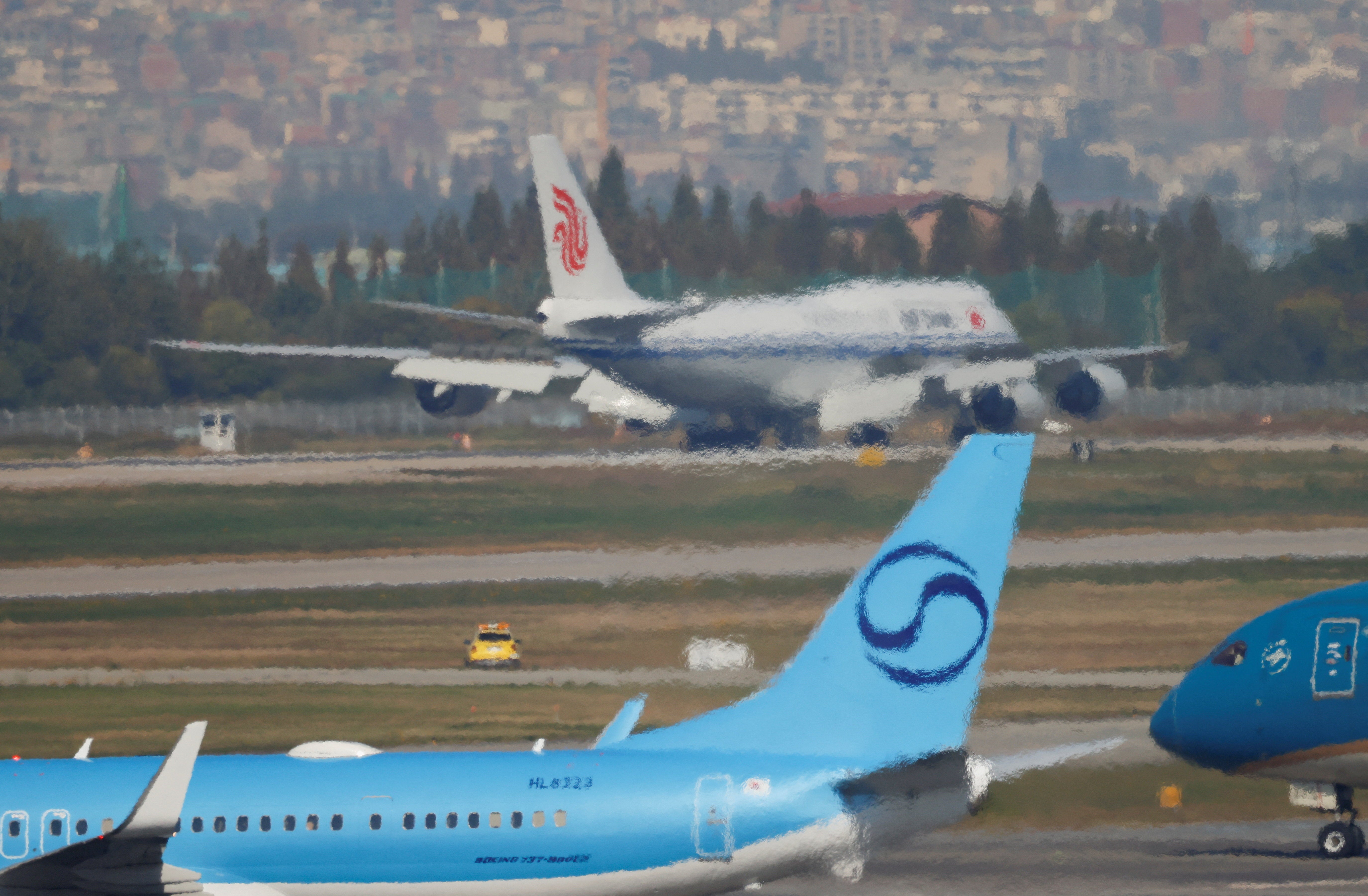 An Air China flight with Chinese President Xi Jinping on board lands at Gimhae International Airport in Busan, South Korea