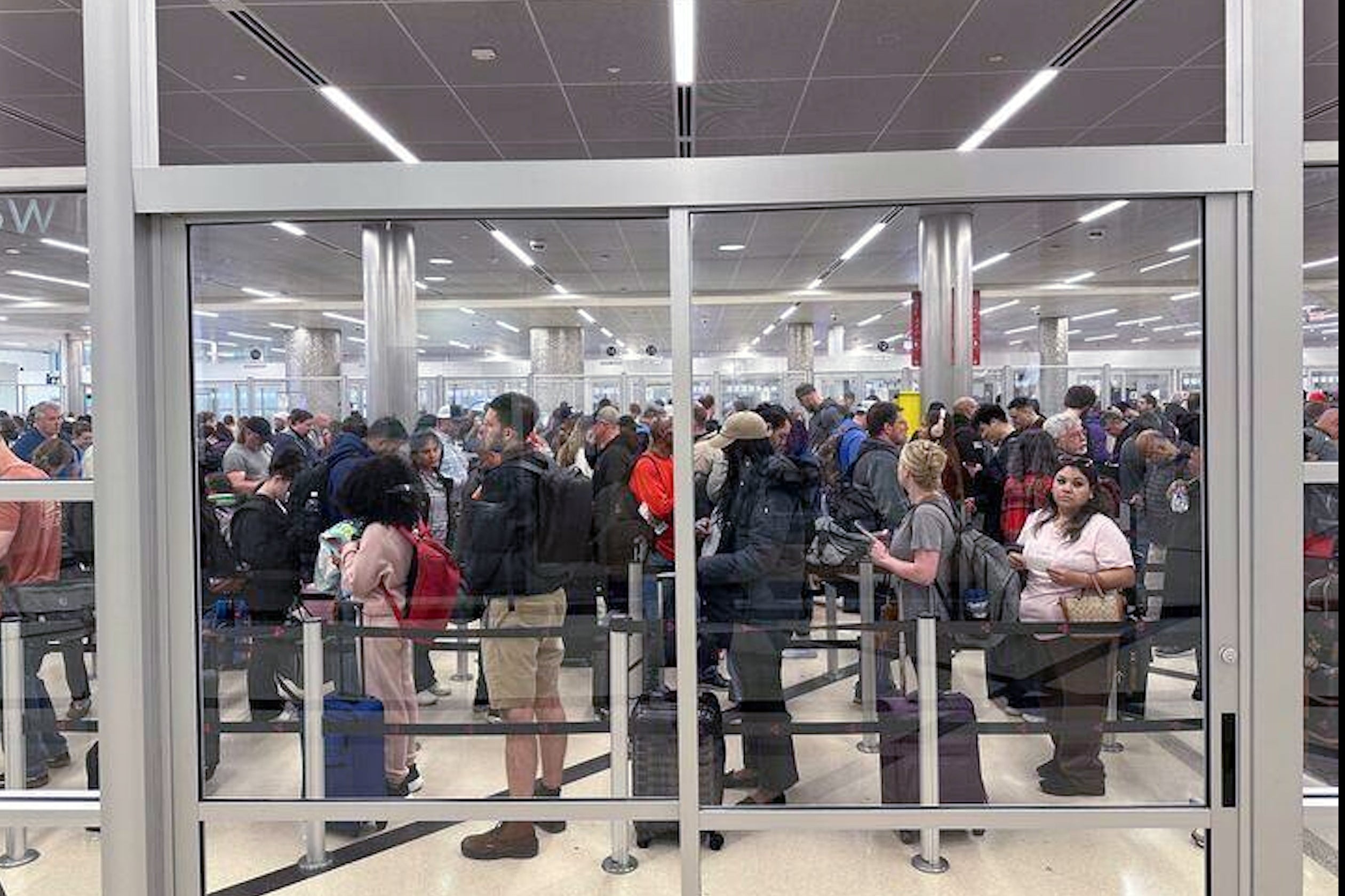 More than 12,500 flights canceled or delayed as storms and TSA issues snarl air travel