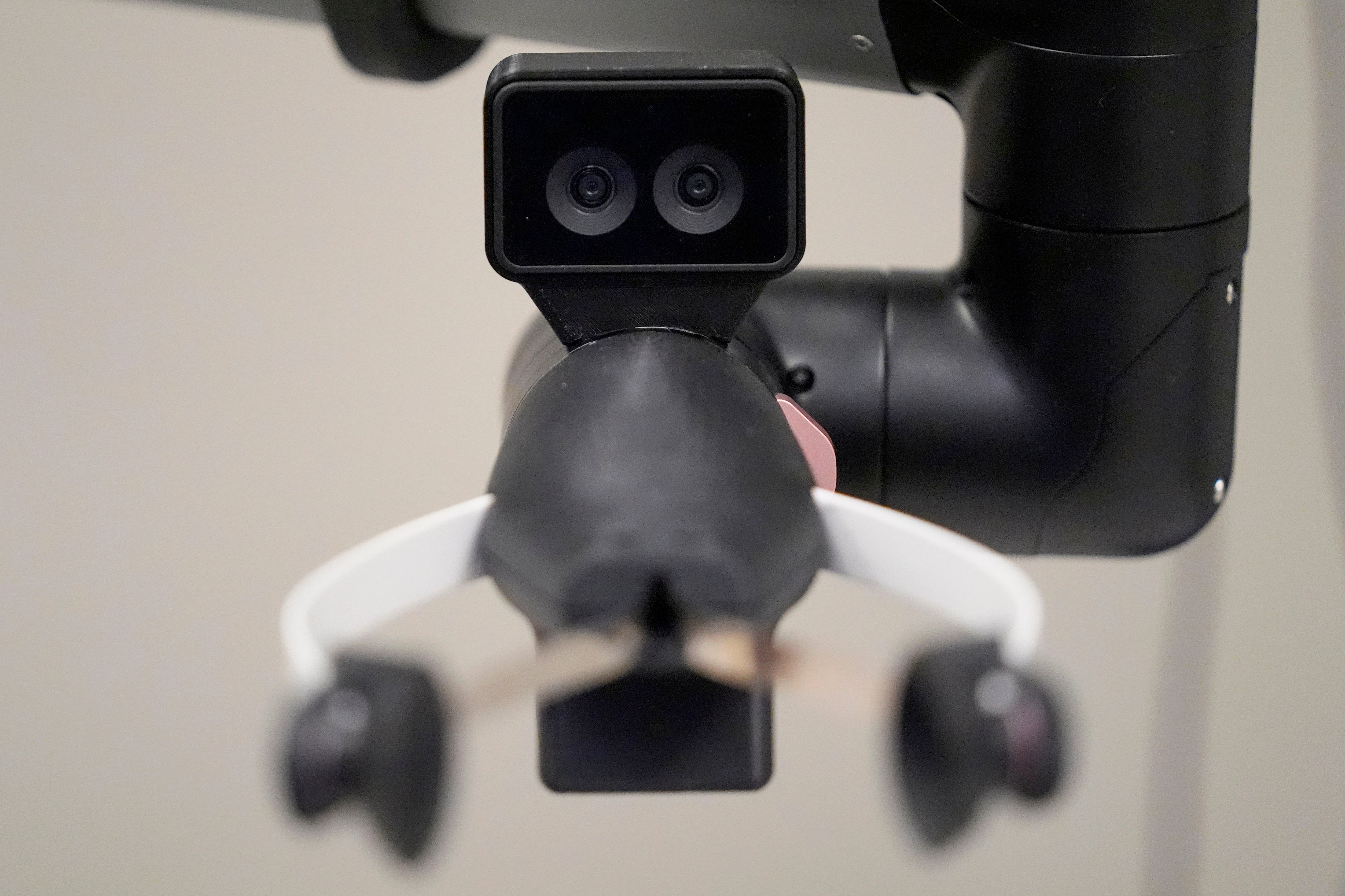 A camera on the hand of a Hello Robot uses two lenses for improved depth perception, during a demonstration