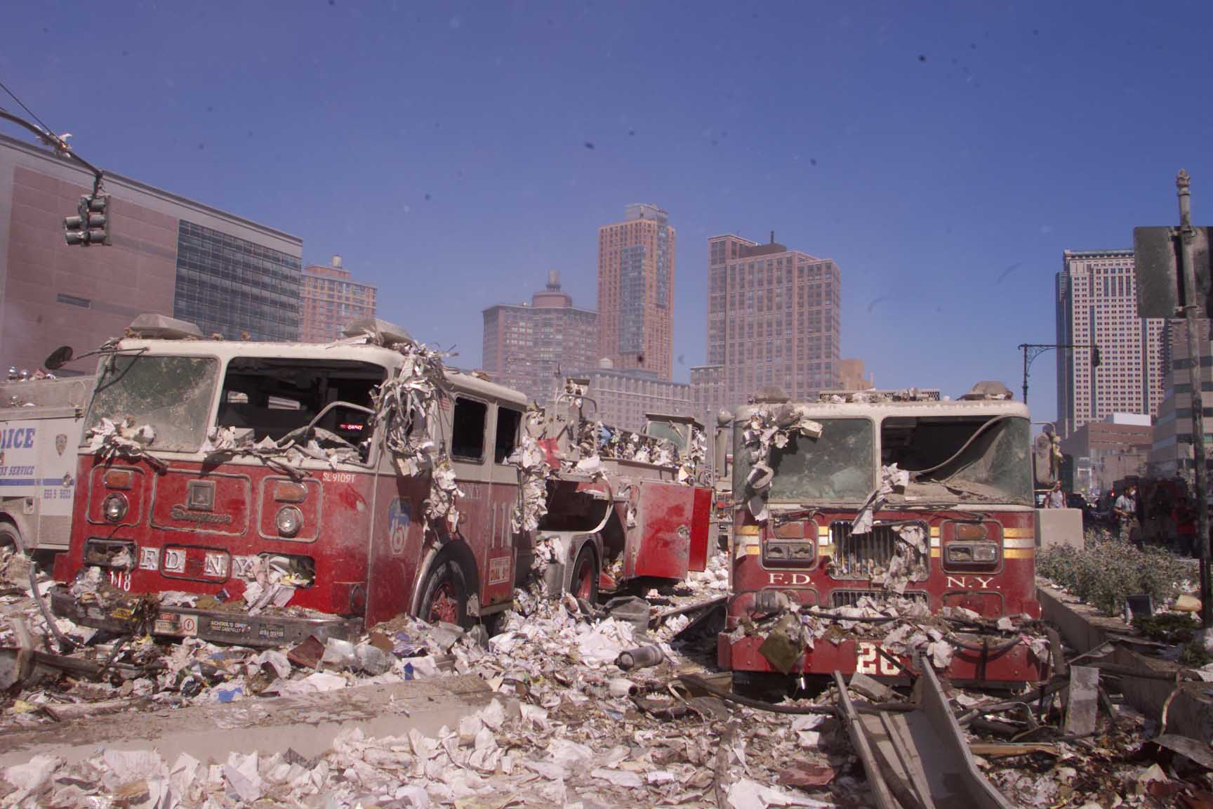 The Ladder 118 fire truck, left, sits demolished following the collapse of the World Trade Center’s twin towers