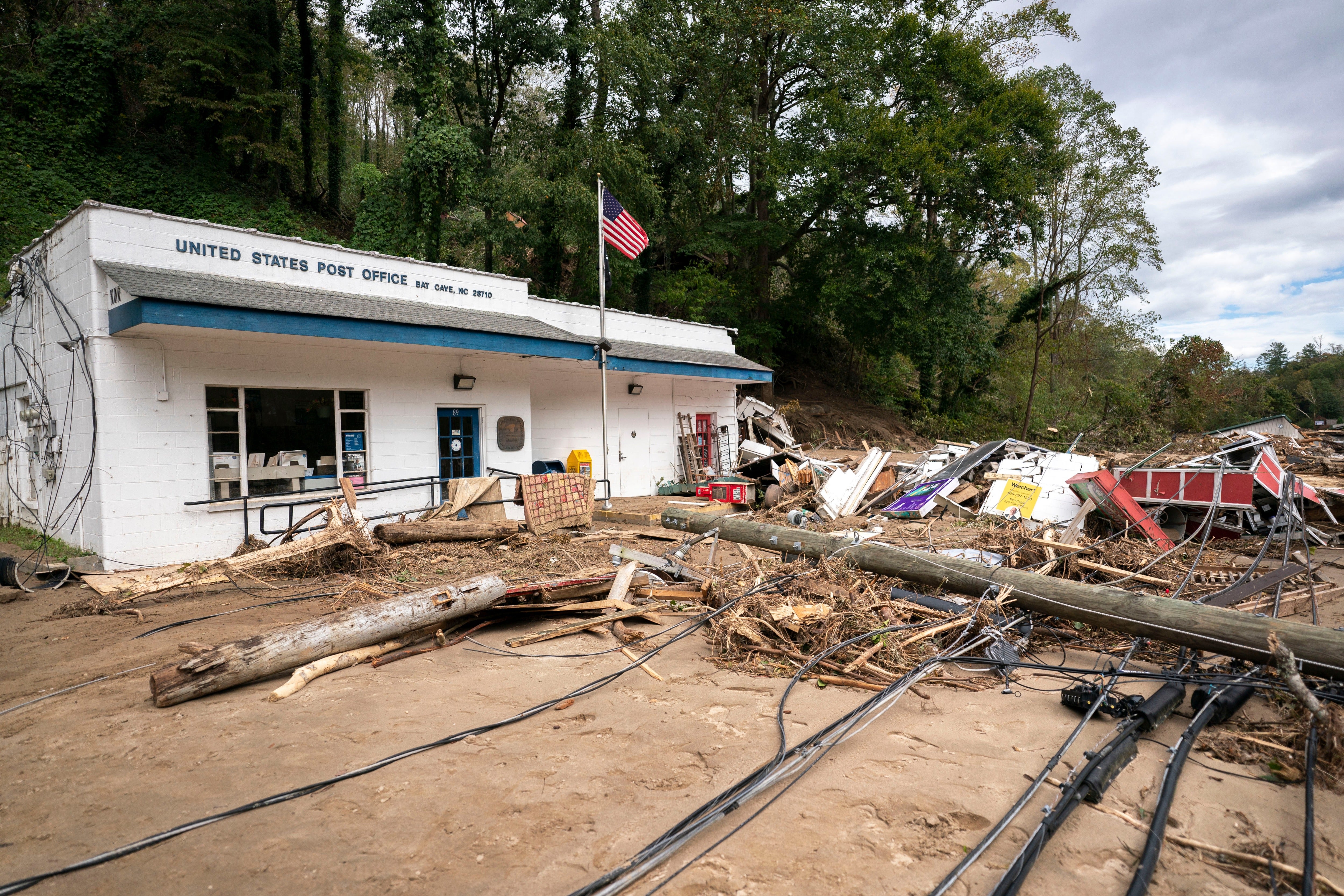 Up to 30 inches (76 centimeters) of rain turned gentle streams into rushing torrents that moved boulders, trees, vehicles, and houses, breaking flood records that had stood for a century