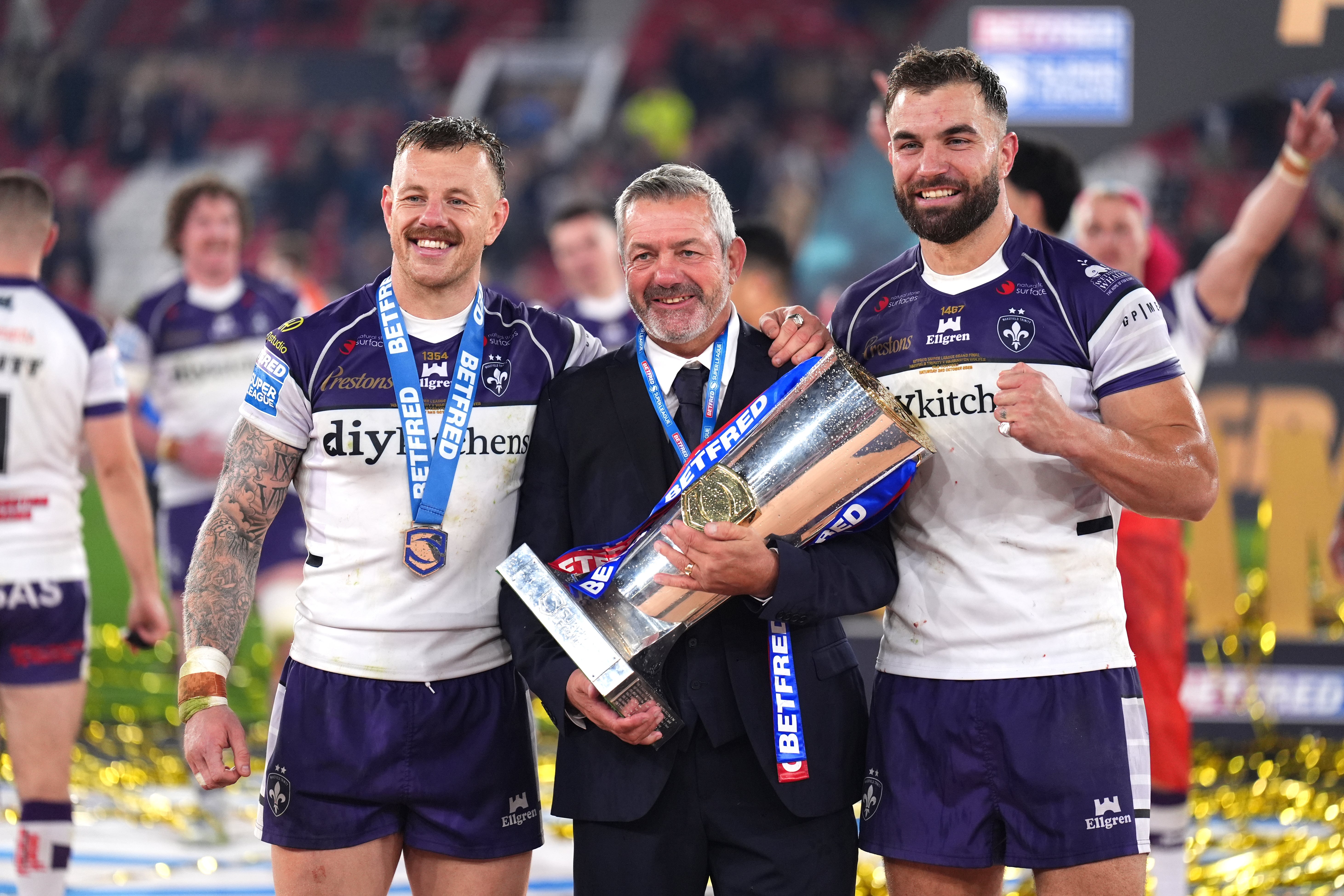 Daryl Powell (centre), Tom Johnstone (left) and Mike McMeeken celebrate with the trophy (Mike Egerton/PA).