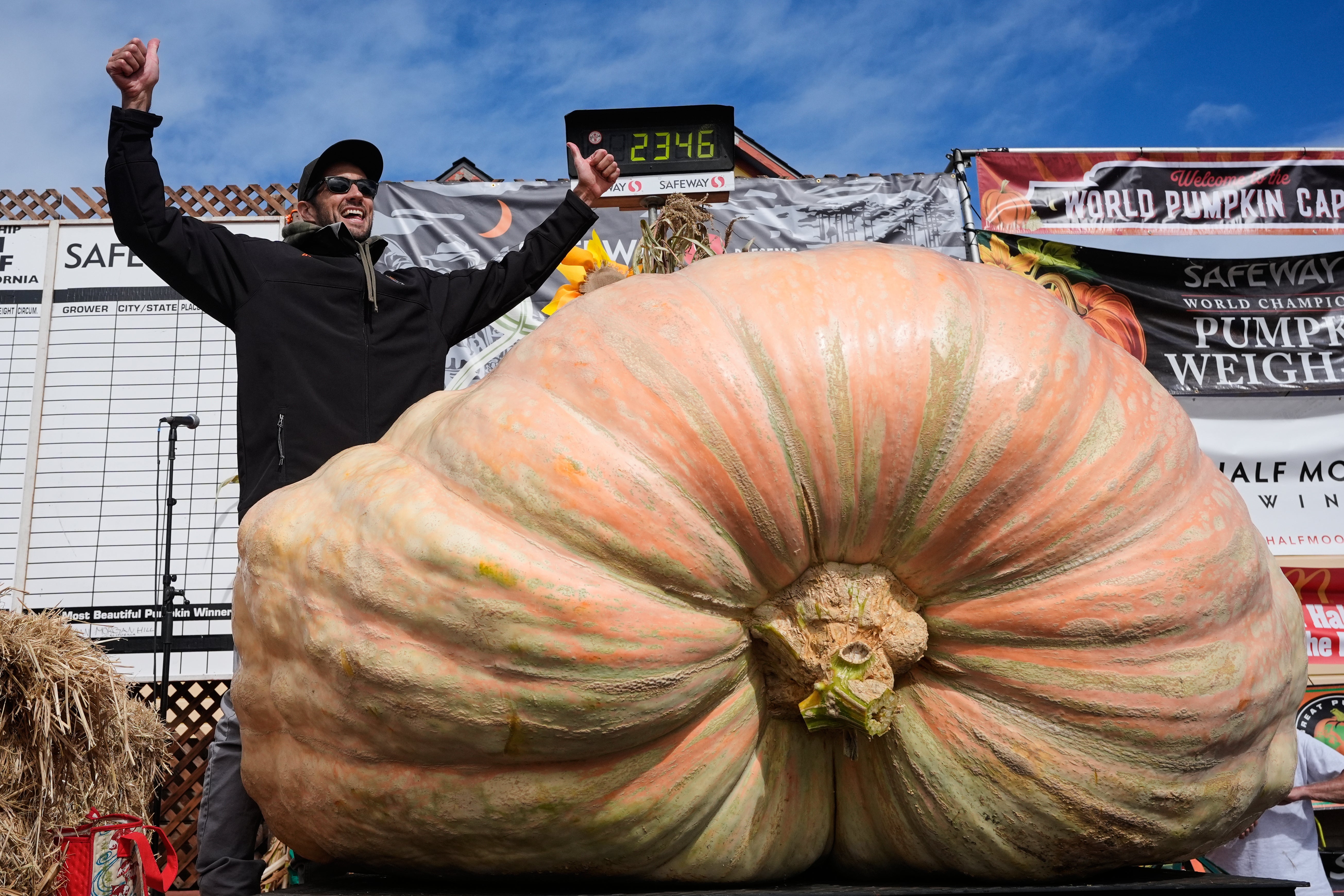 Brandon Dawson, left, celebrates after winning the Safeway 52nd annual World Championship Pumpkin Weigh-Off in Half Moon Bay, in 2025
