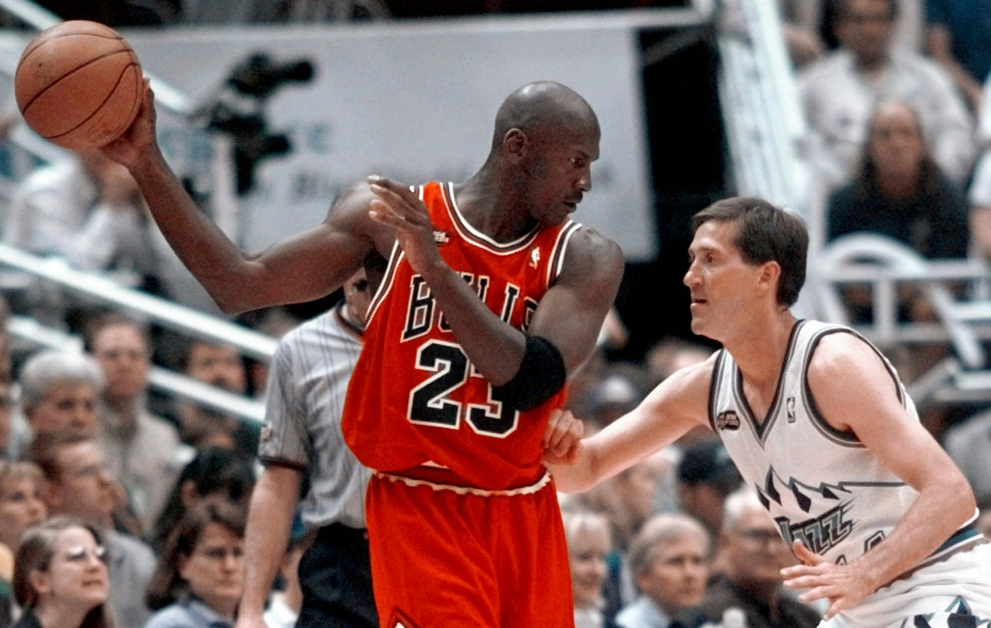 Chicago Bulls' Michael Jordan pulls the ball out of reach of Utah Jazz guard Jeff Hornacek during third quarter action in Game 2 of the NBA Finals in Salt Lake City