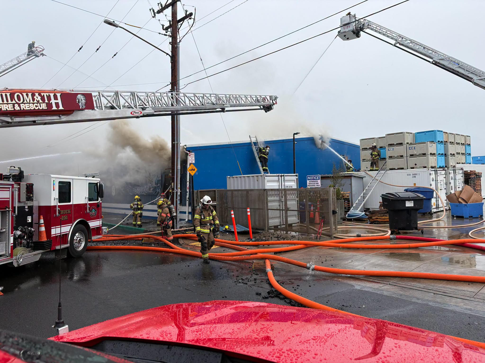 Emergency crews converged on the Pacific Seafood facility, successfully keeping flames away from the chemical tanks while continuing to battle the blaze into Sunday evening