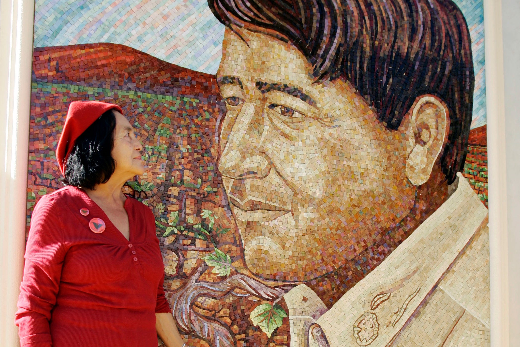 Huerta looks at a mural of the late Cesar Chavez during a dedication of the Cesar Chavez Monument on the San Jose State University campus in San Jose, Calif., Sept. 4, 2008