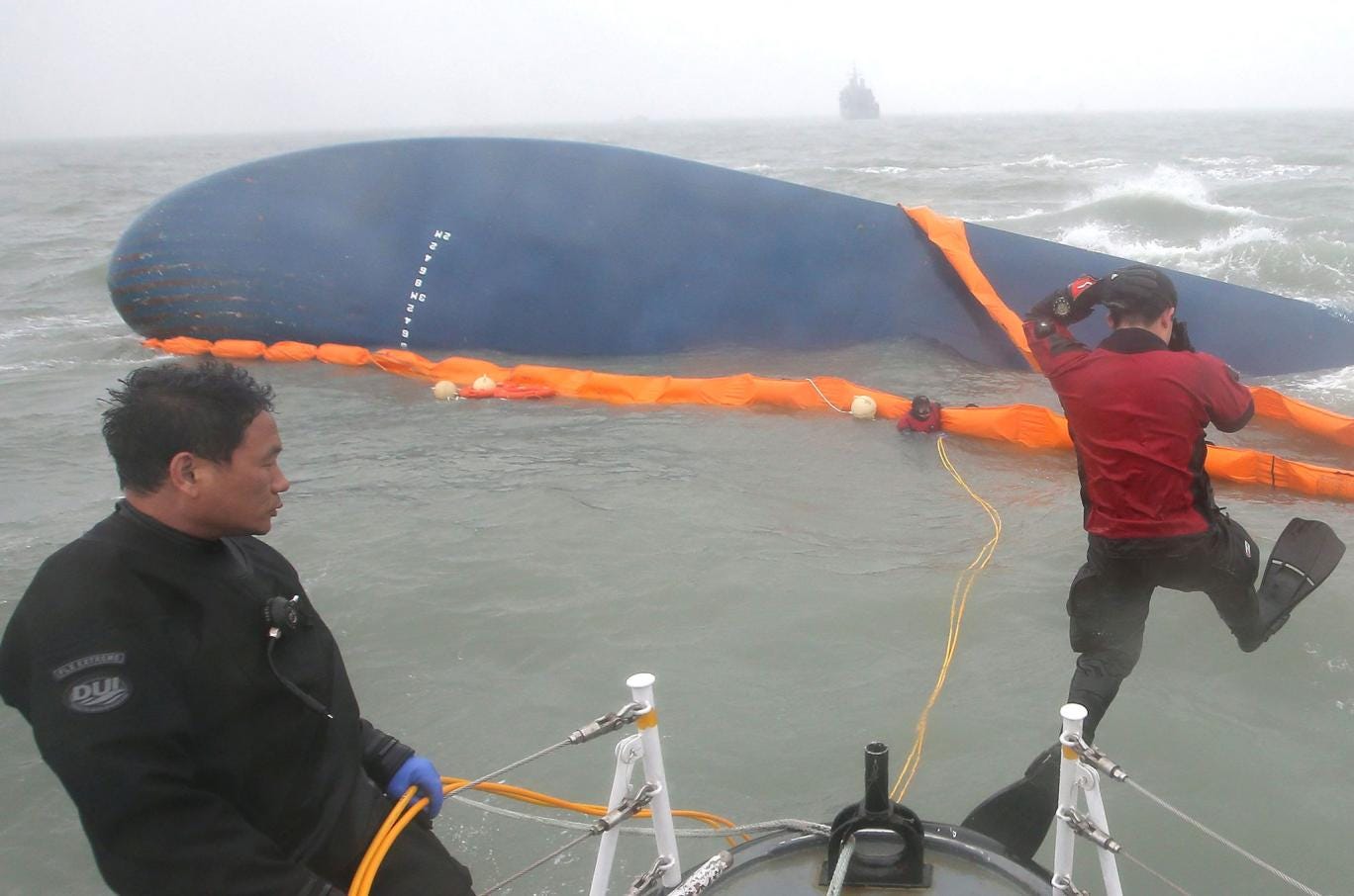 Civilian divers jump into the sea to search for missing passengers in the sinking of the ferry Sewol off South Korea's southwestern coast  
