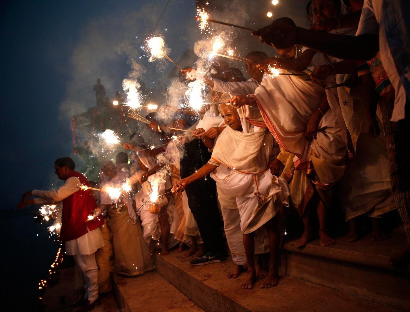 Widows, who have been abandoned by their families, light sparklers after offering prayers on the banks of the river Yamuna as part of Diwali celebrations organised by non-governmental organisation Sulabh International in Vrindavan, in the northern Indian 