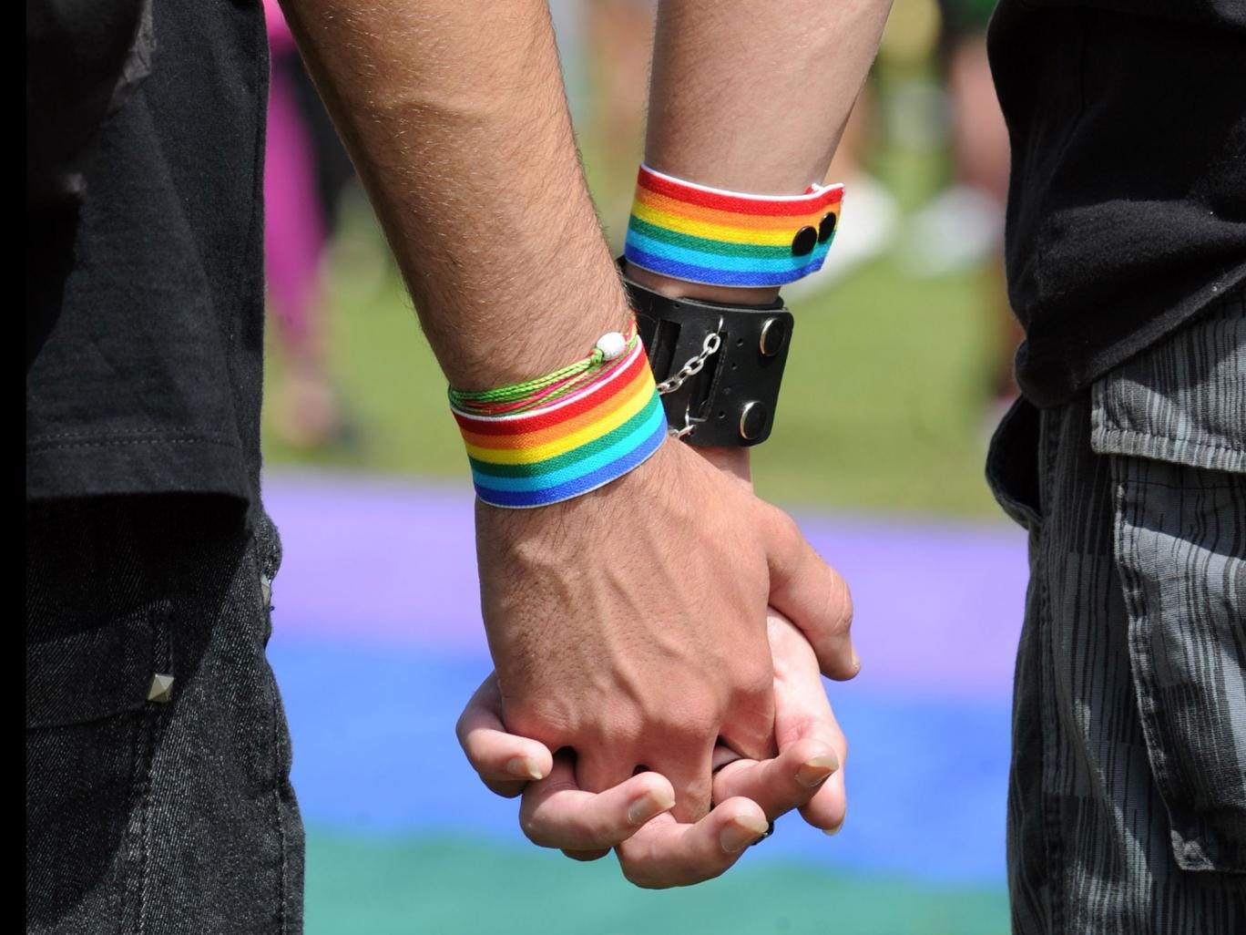 A gay couple holds hands