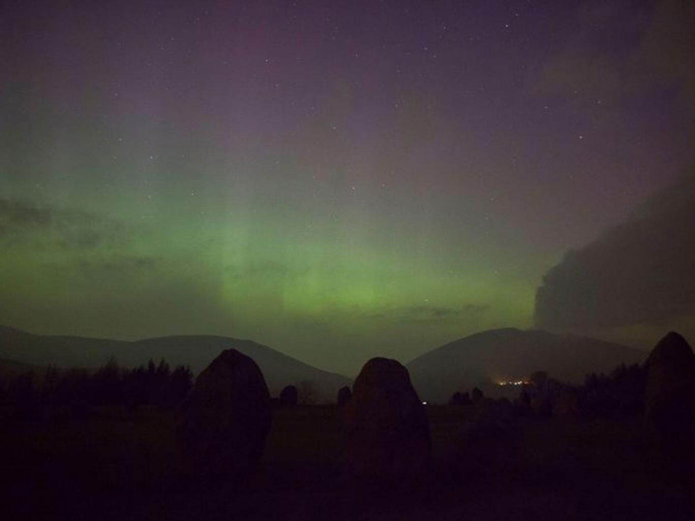 The aurora borealis, or the northern lights as they are commonly known, at Castlerigg Stone Circle in the Lake District, with Blencathra and Skiddaw behind. 