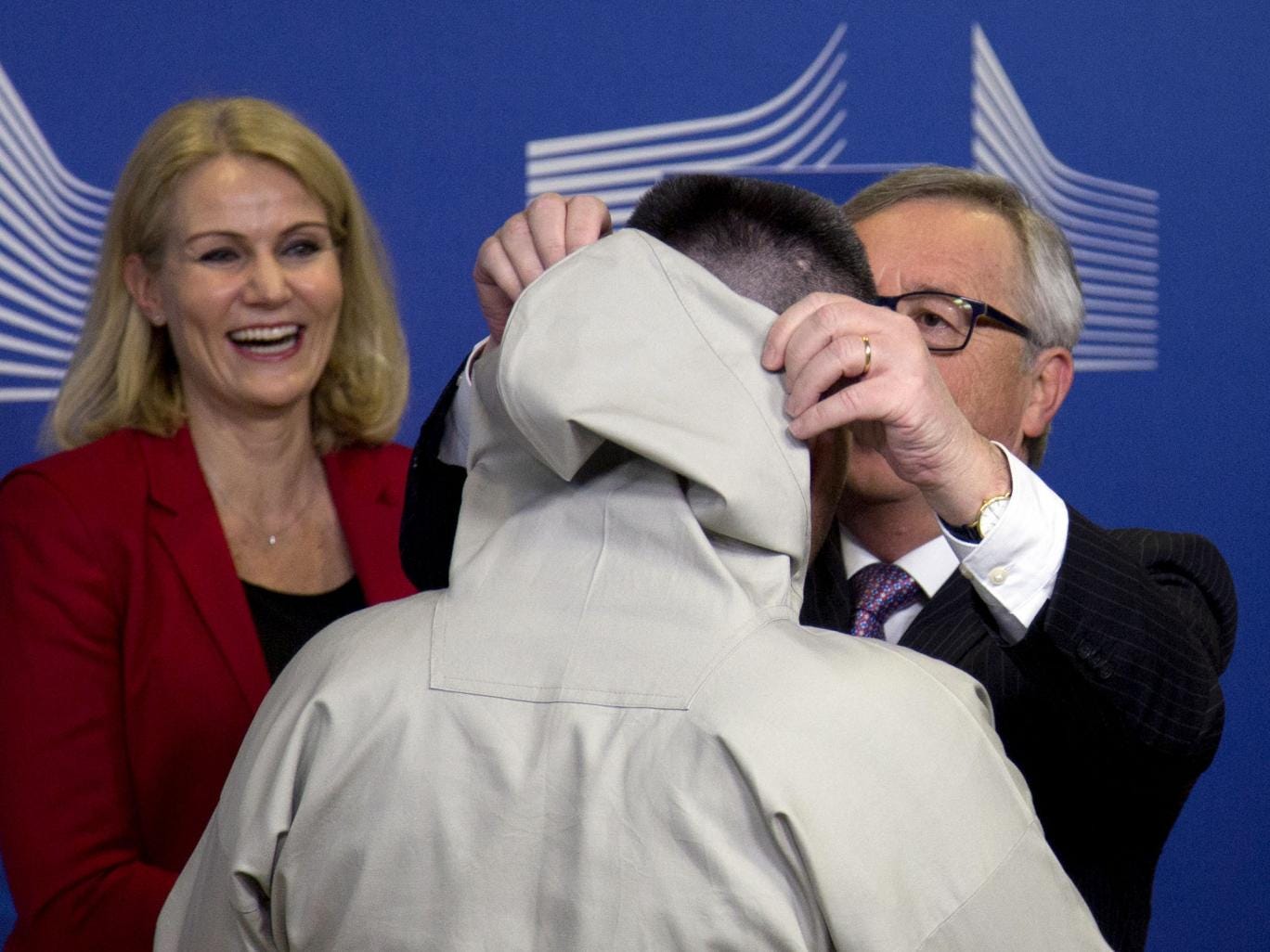 Helle Thorning-Schmidt looks on as Jean-Claude Juncker  adjusts Kim Kielsen’s ‘hood’