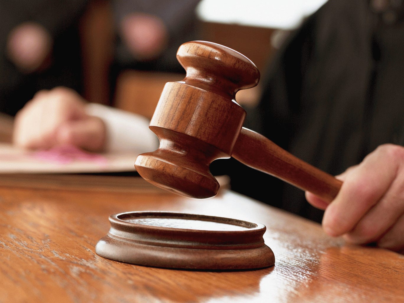 Close up of a judge raising gavel in a courtroom