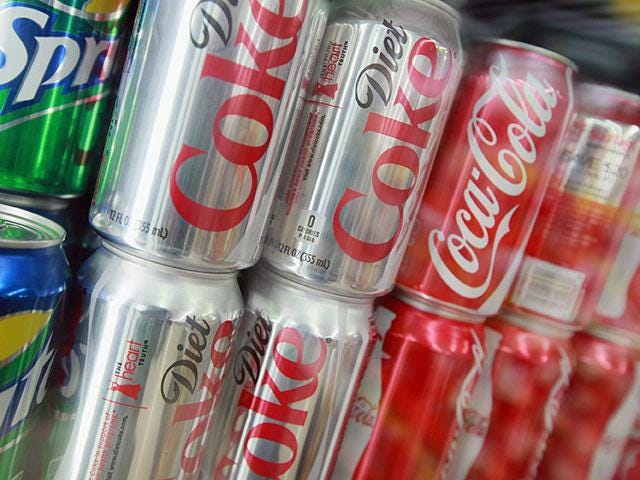 The report suggests that sugary, carbon-dioxide-filled fizzy drinks could be banned from schools (Getty)