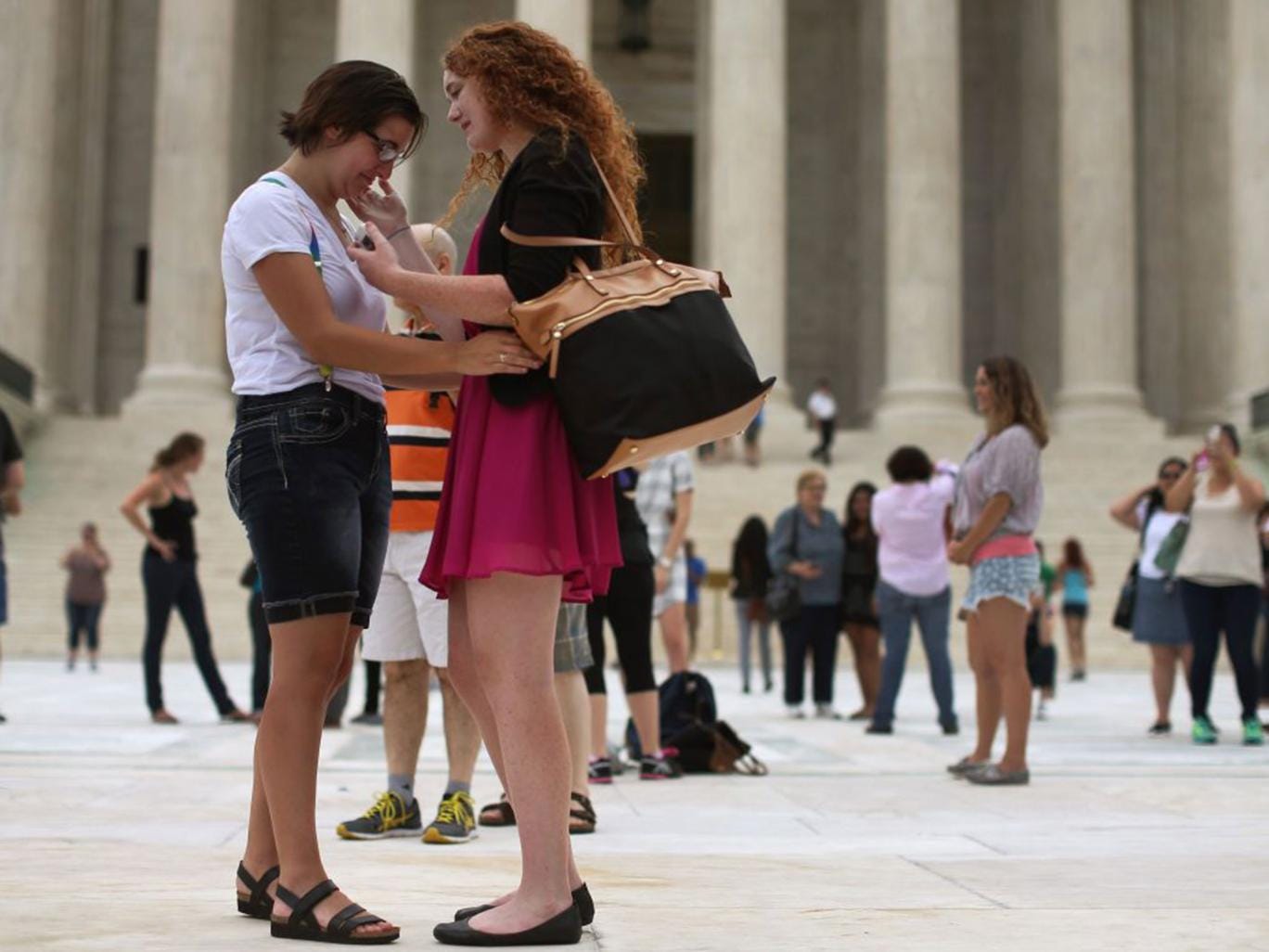 Ariel Cronig (L) and Elaine Cleary embrace outside of the US Supreme Court after the ruling in favor of same-sex marriage 