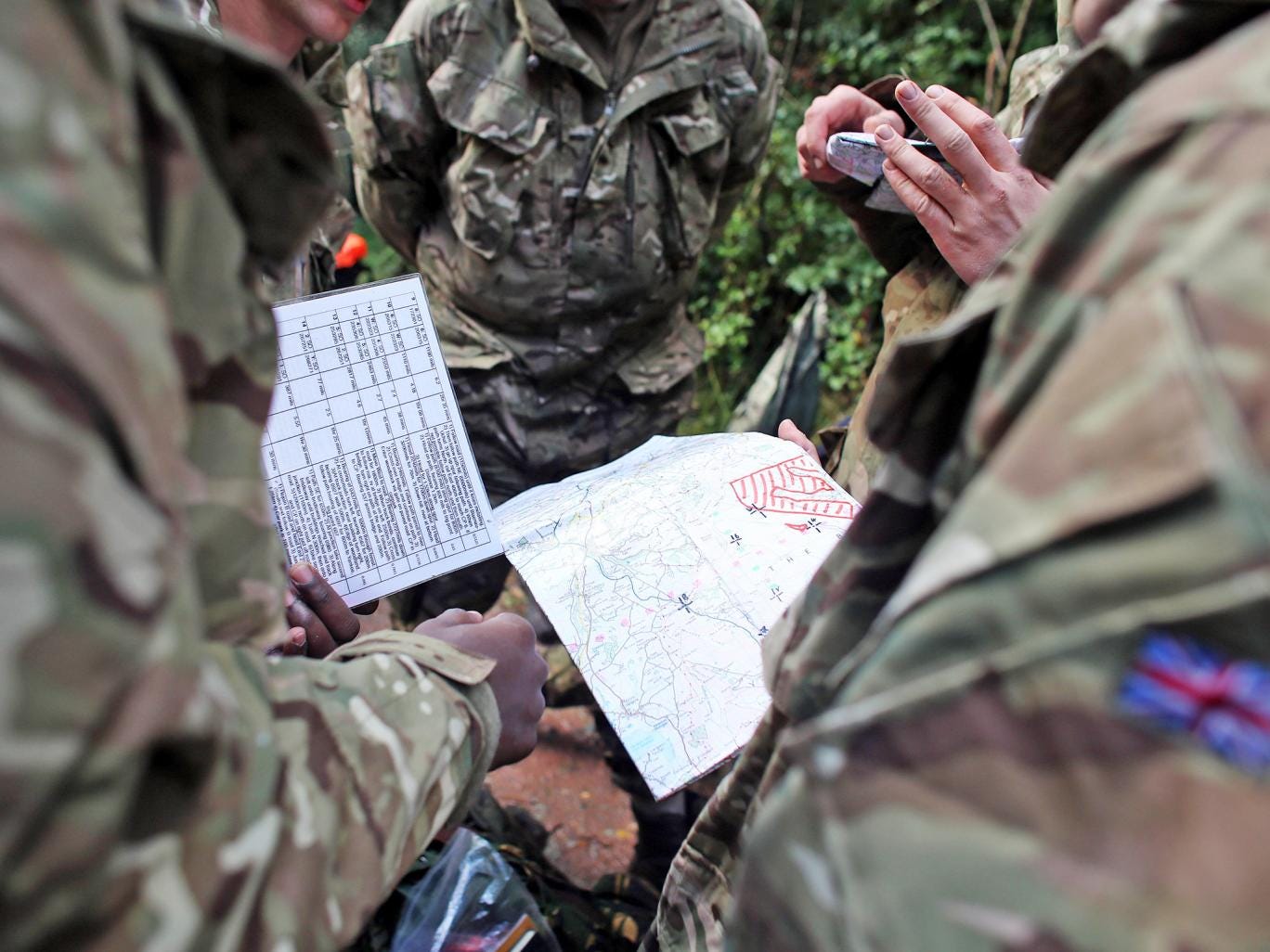British Army cadets check their maps during an exercise in the Brecon Beacons
