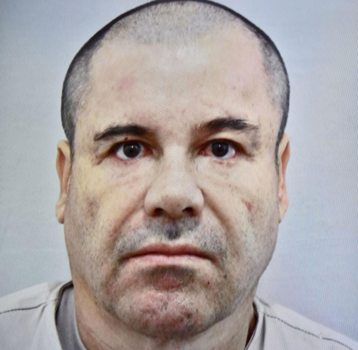 Picture taken from a tv screen  of Mexican drug kingpin Joaquin "El Chapo" Guzman displayed during a press conference held at the Secretaria de Gobernacion in Mexico City, on July 13, 2015.