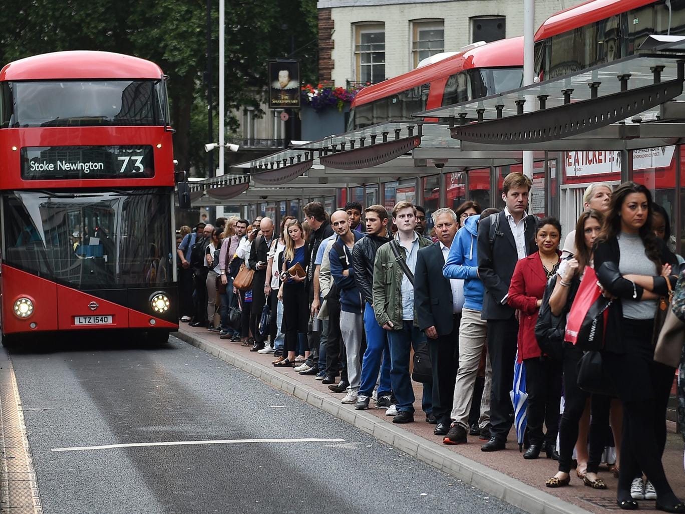 Commuters queue for buses during a Tube strike at Victoria Station