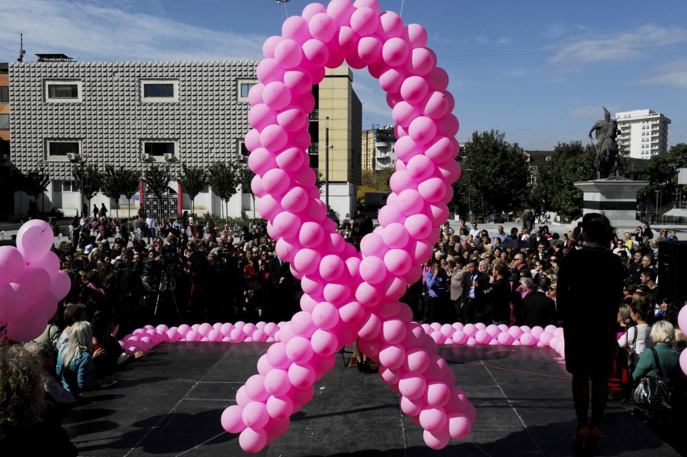 Pink balloons hang on a stage during an event to raise awareness on breast cancer in Pristina in October 2013