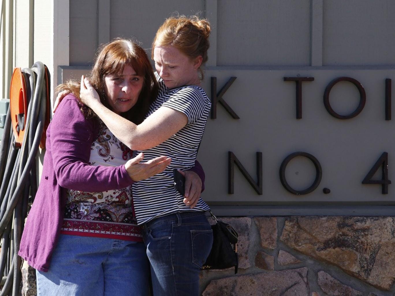 Umpqua Community College alumnus Donice Smith, left, is embraced after she said one of her former teachers was shot dead, near the site of a mass shooting at Umpqua Community College in Roseburg,Oregon 