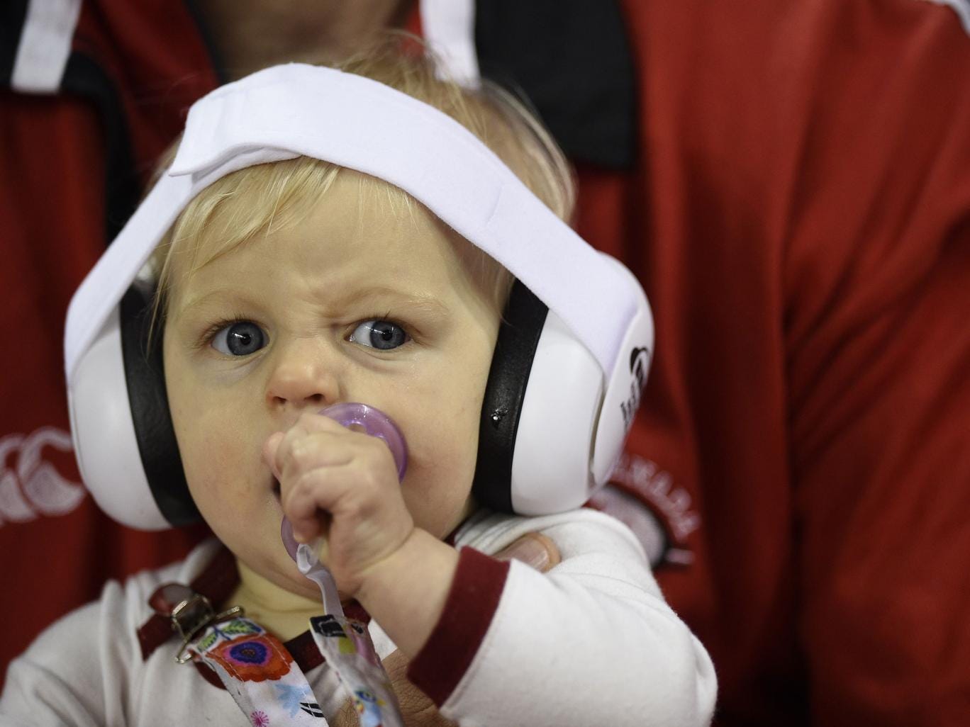 A toddler wears ear-defenders in the crowd during the Pool A match of the 2015 Rugby World Cup between Wales and Uruguay at the Millennium Stadium in Cardiff
