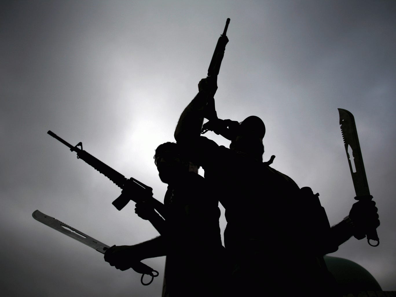 Iraqi fighters from the Saraya al-Salam (Peace Brigades) wave their weapons as they leave the holy city of Najaf in a convoy with Iraqi government forces to head to the northern Iraqi city of Tikrit to continue the offensive against Islamic State (IS) gro