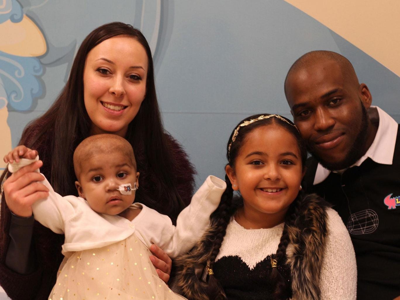 Layla Richards with her parents, Lisa Foley and Ashleigh Richards, and her sister, Reya