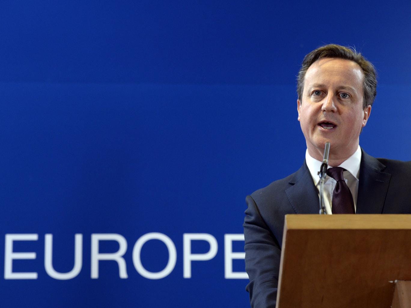 British Prime Minister David Cameron talks to the media at the end of a European Union Summit held at the EU Council building in Brussels