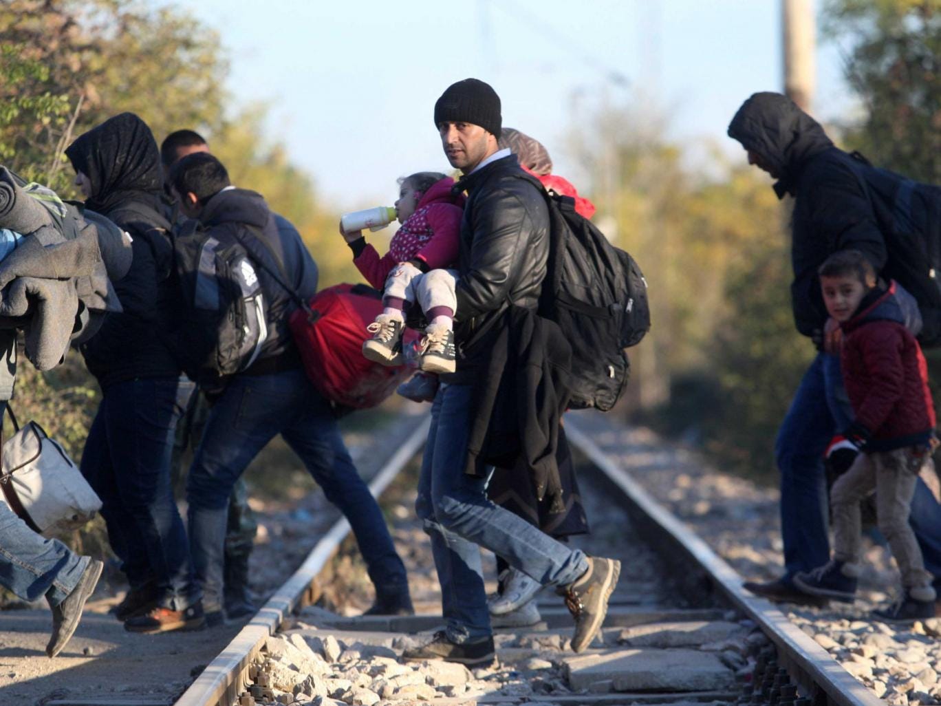 Refugees cross the border from Greece to Macedonia near the village of Idomeni 