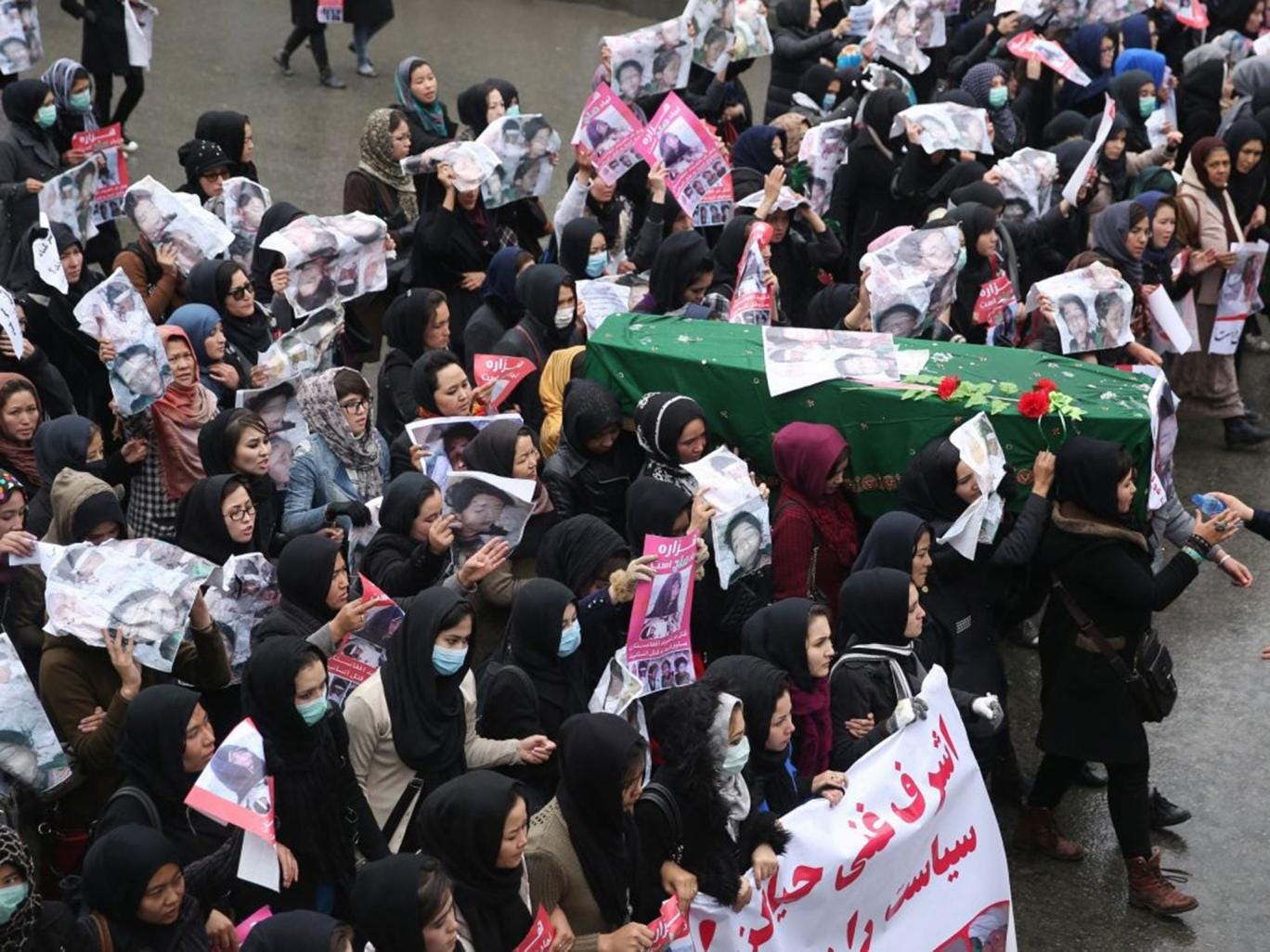 Women carry the coffin of a nine-year-old girl as thousands march in the Afghan capital of Kabul 