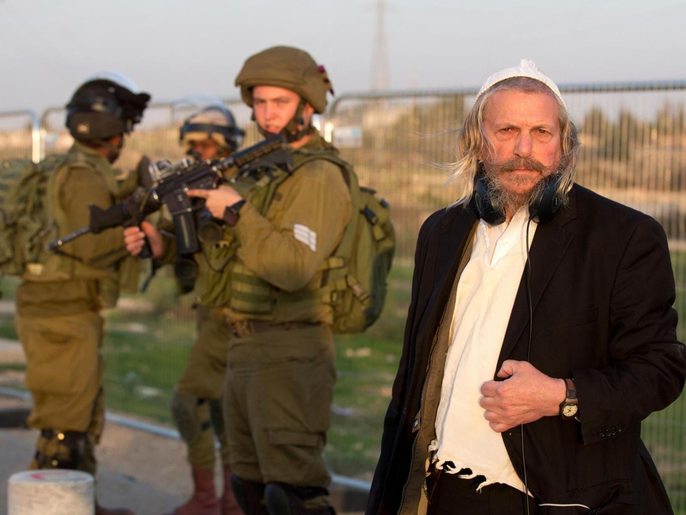 IDF soldiers stand guard at the bus stop where Hadar Buchris was killed