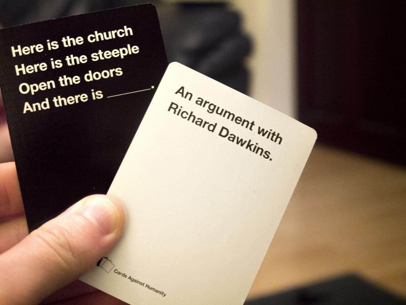 A white card and a black card from Cards Against Humanity.