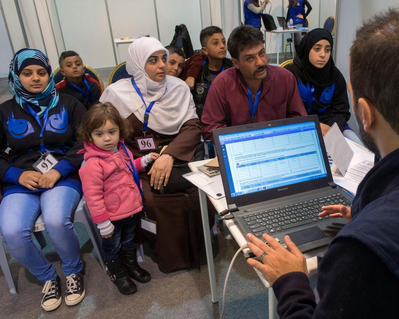 Syrian refugee family being interviewed at screening