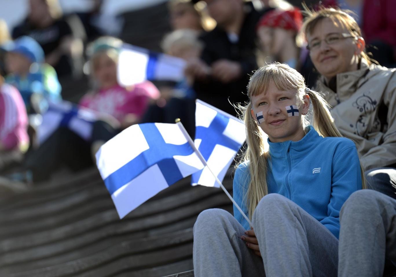 Girl holds a Finnish flag at the 2012 European Athletics Championships