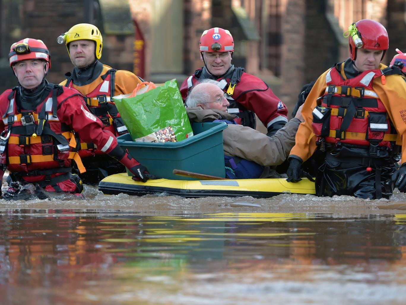 A rescue team helps to evacuate people from their homes after Storm Desmond caused flooding 