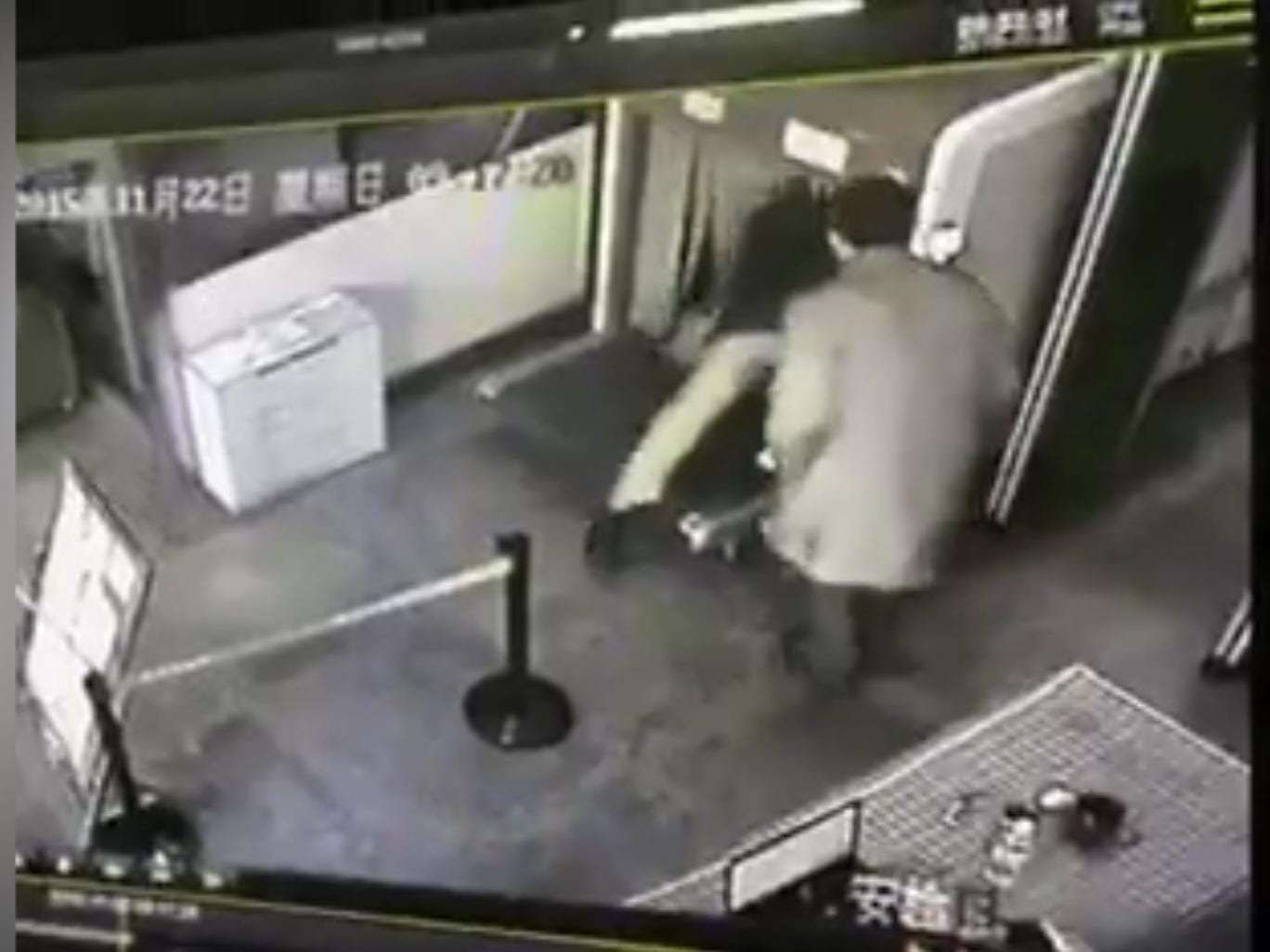 MAN CLIMBS INTO SECURITY SCANNER ON CONVEYOR BELT AT TRAIN STATION