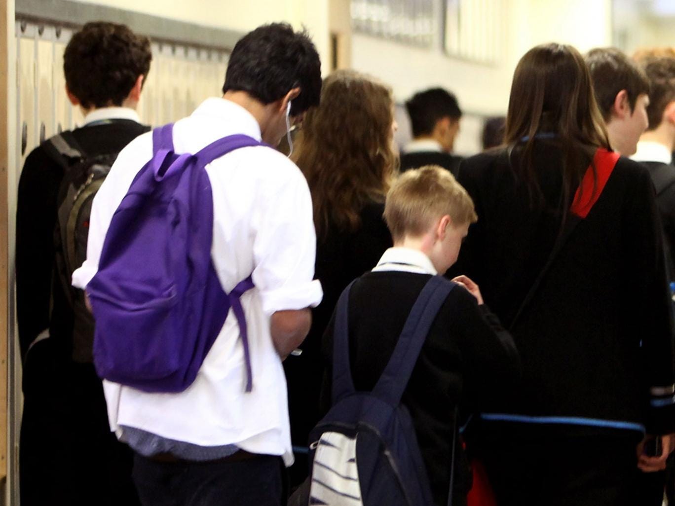 Pupils at Williamwood High School make their way to classes 