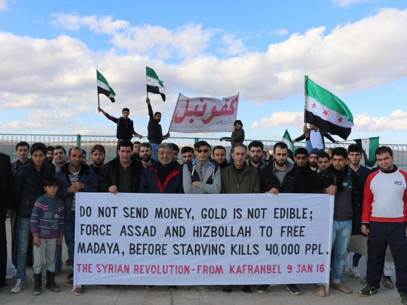A banner displayed in Kafr Nabl that was created by Raed Fares and Hadi al-Adbullah