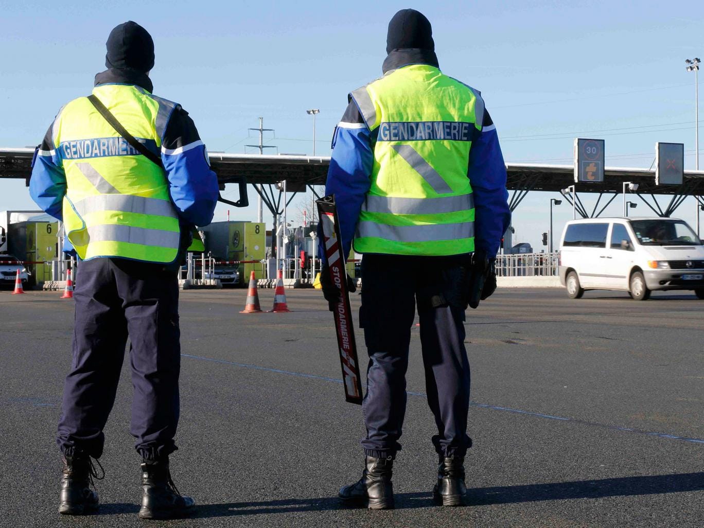 Armed French gendarmes stand next to a toll station as they check vehicles and verify the identity of travellers on the A2 motorway between Paris and Brussels