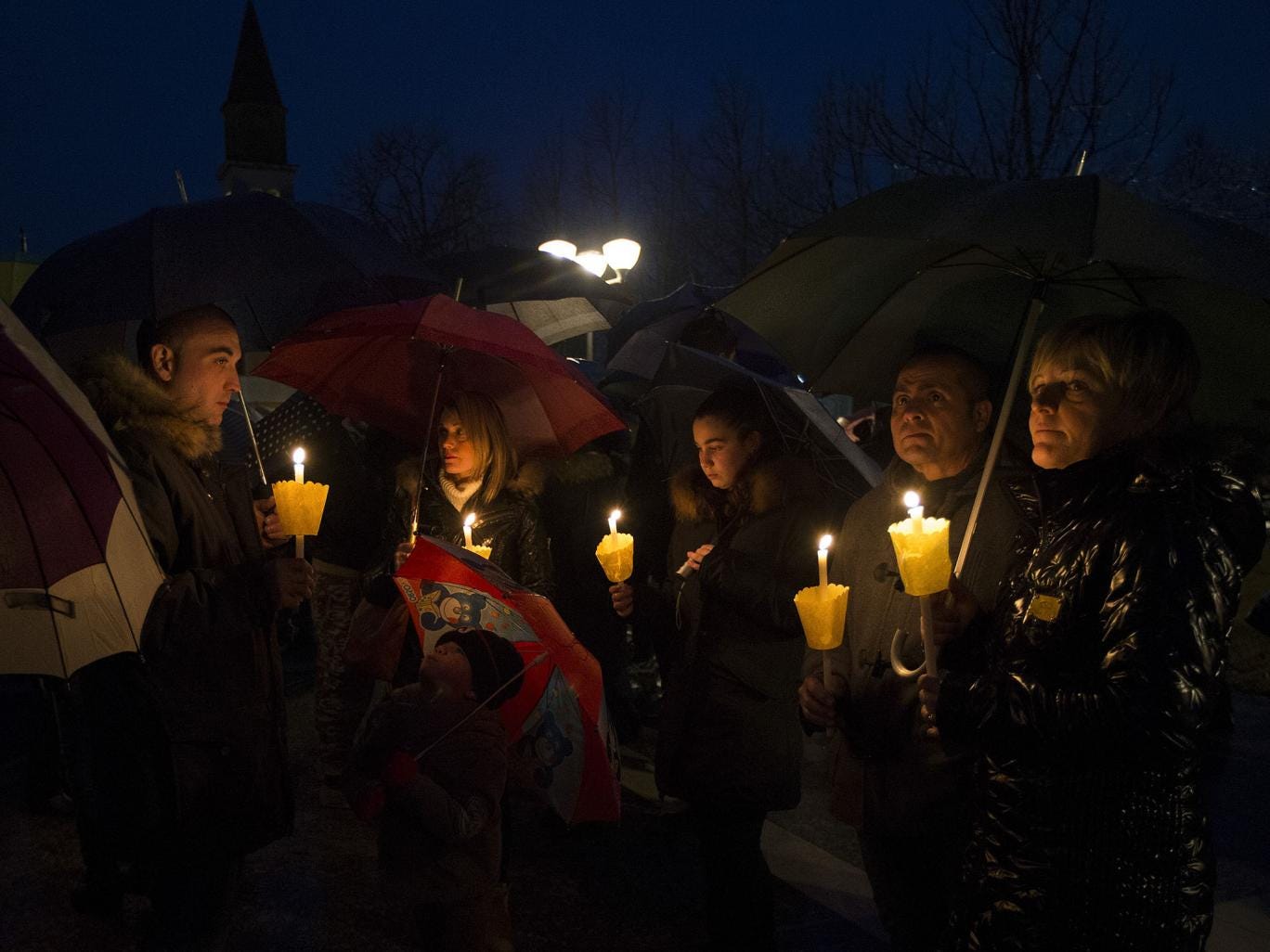 People gather during a candle light procession to honor the memory of  Giulio Regeni in Fiumicello, Italy, 