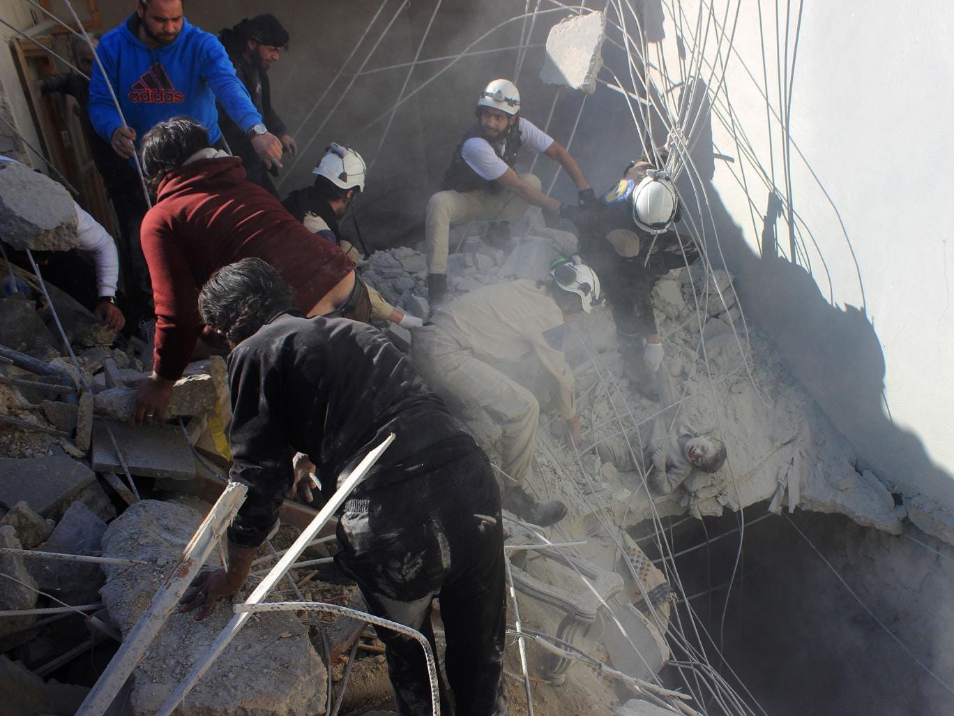 Members of the civil defence pull a boy out from under the rubble of a building following air strikes by suspected Russian warplanes backing the Syrian government on the Sahour neighbourhood of the northern Syrian city of Aleppo on February 16, 2016. 