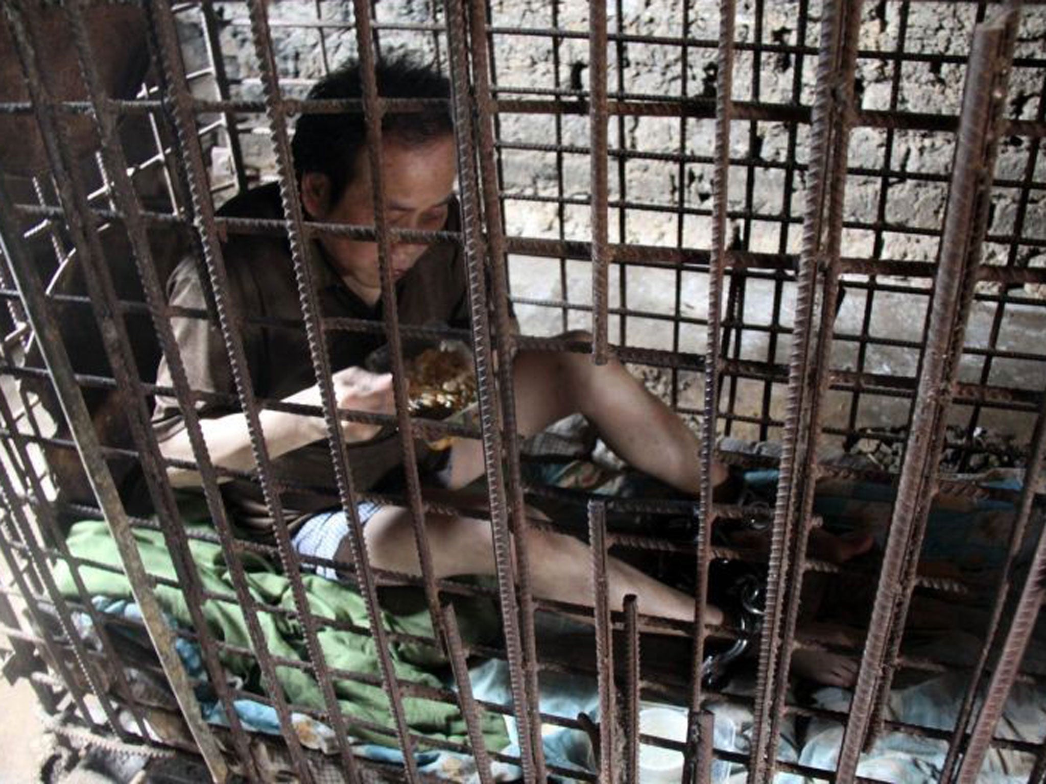 Asian man in cage one year