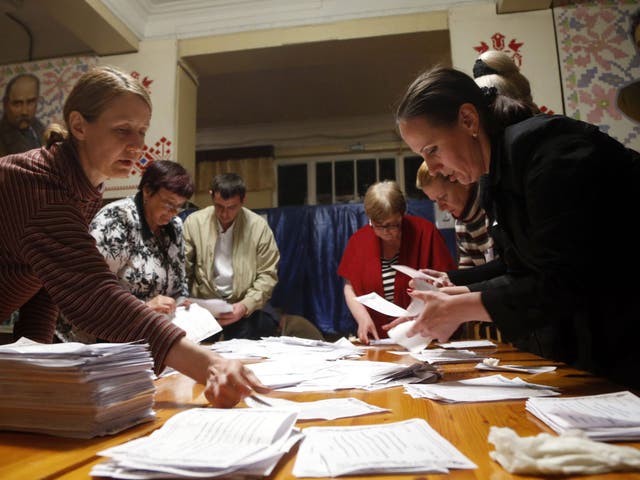 Members of a local election commission count votes after a referendum organized by the so-called Donetsk People's Republic members at a polling station in Donetsk 