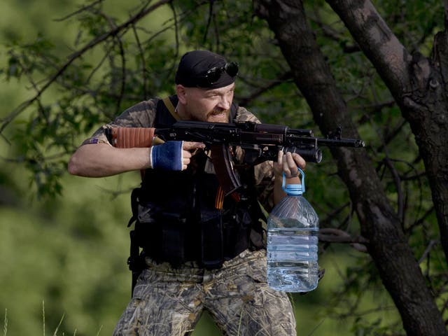 A pro-Russian gunman aims his weapon near the airport, outside Donetsk. Ukraine's military launched air strikes against separatists who had taken over the airport in the eastern capital of Donetsk in what appeared to be the most visible operation of the Ukrainian troops since they started a crackdown on insurgents 
