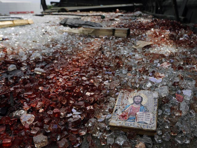 A bloodstained icon of Jesus is seen among blood soaked shattered glass atop a wrecked truck near the Donetsk airport 
