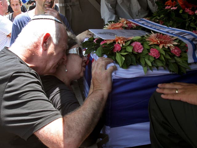 The parents of 32-year-old Israeli army captain Tzafrir Bar-Or, a commander of the Golani Brigade killed the previous day fighting a group of Palestinian militants in the Gaza Strip, mourn over his coffin during his funeral in the central town of Holon, near Tel Aviv 