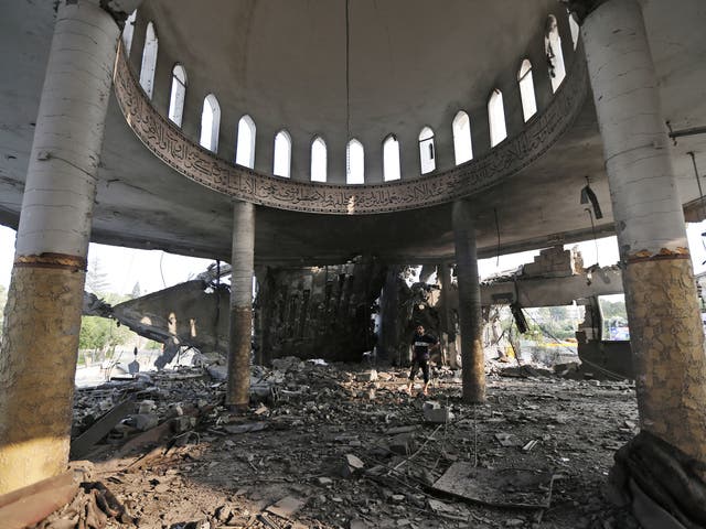A Palestinian walks inside the Al Aqsa Martyrs mosque destroyed by an Israeli strike in Gaza City 